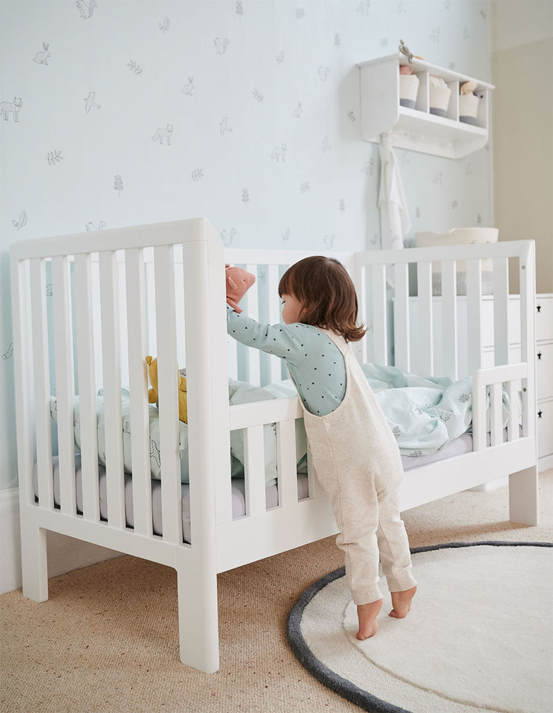 White toddler bed in nursery