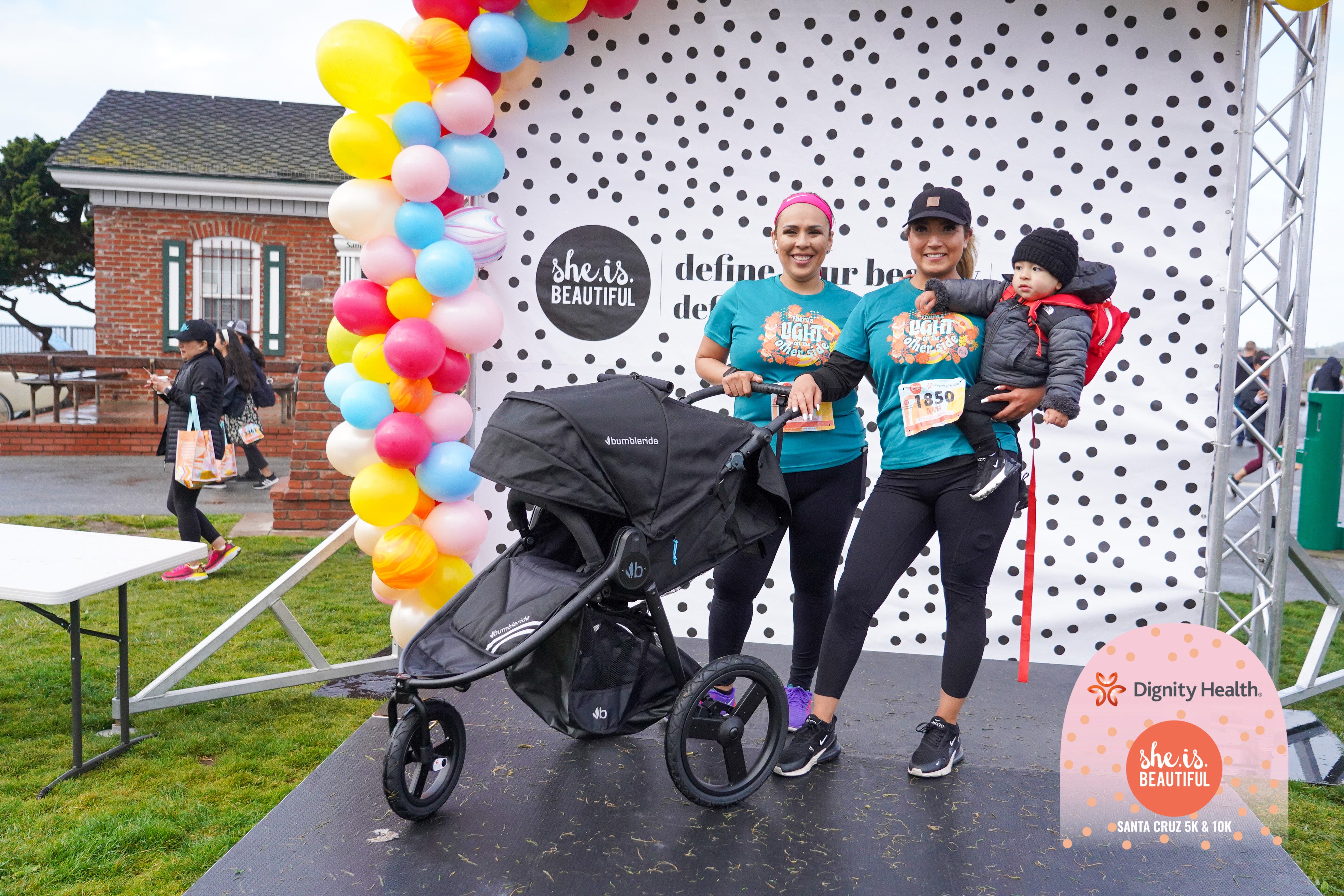 Picture of mom and child on award podium at She Is Beautiful 5k/10k