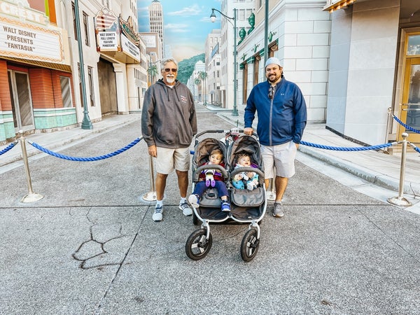 Picture of father and grandparent with Indie Twin at Disneyland