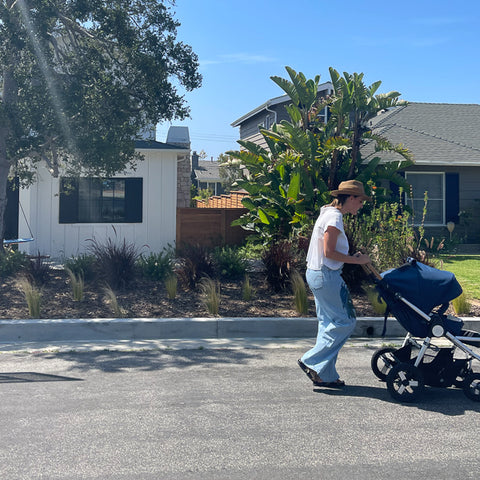 Aida Garcia-Toledo pushing Bumbleride Era Reversible Stroller on street in neighborhood