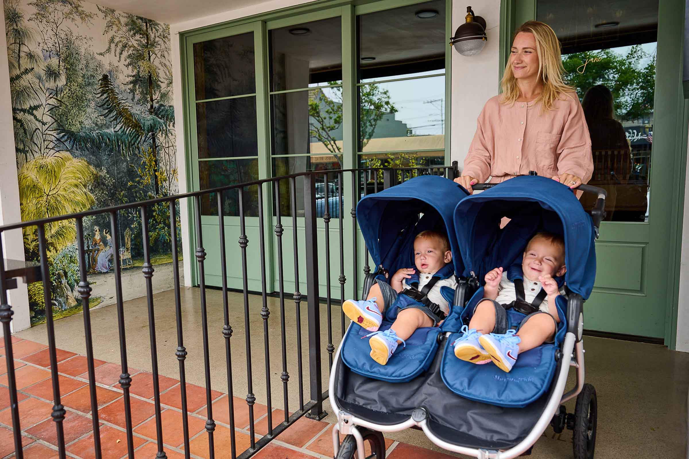 Picture of mother pushing twins in a 2022 Bumbleride Indie Twin Double Stroller in Maritime.