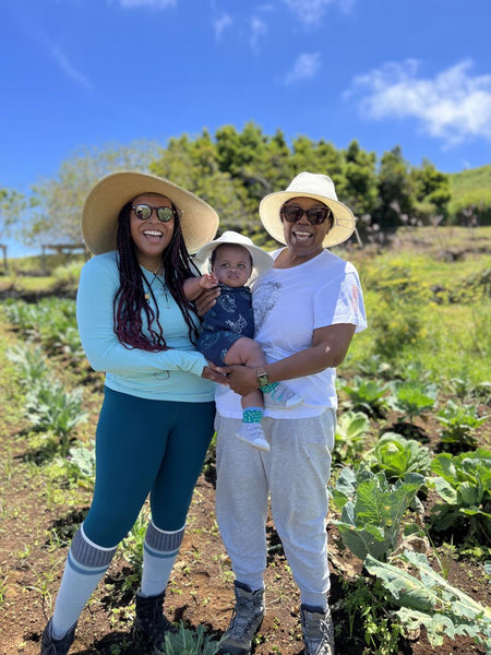 Kirby and Oprah holding Baby Luca in Oprah's Garden