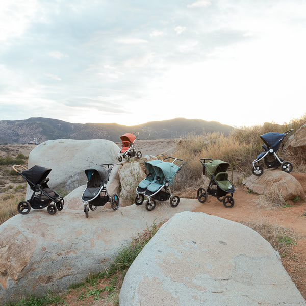 Lineup of Bumbleride strollers in desert