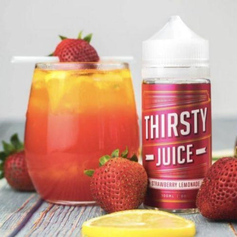 Thirsty Juice Co | Strawberry Lemonade 100ml bottle with 4 strawberries and a glass of strawberry juice with a slice of lemon