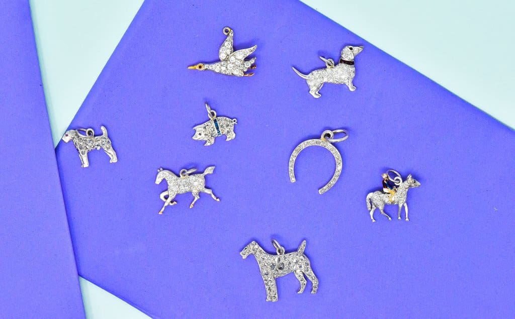 A large Selection of antique art deco diamond charms for bracelet