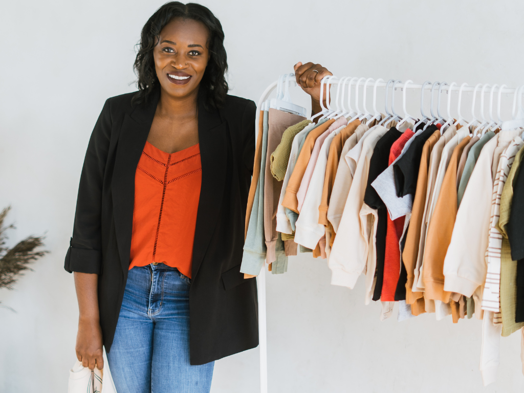 Owner leaning on clothing rack