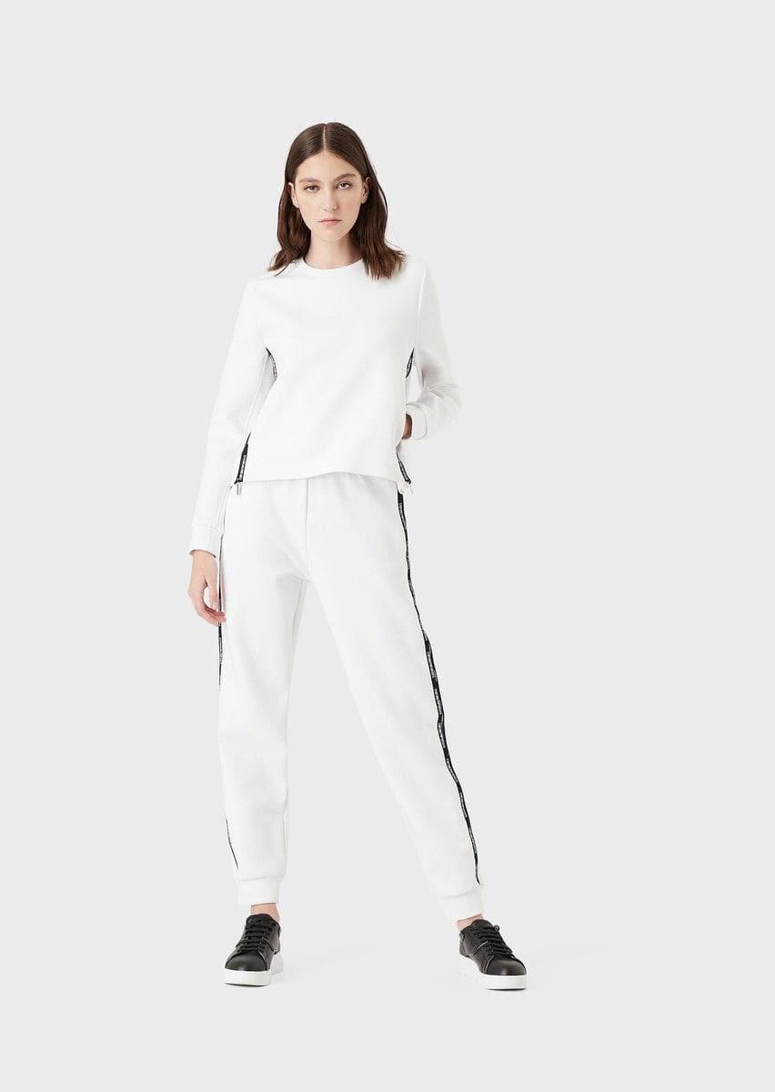 Image of Pantaloni jogger in double jersey con tape logo e zip laterale