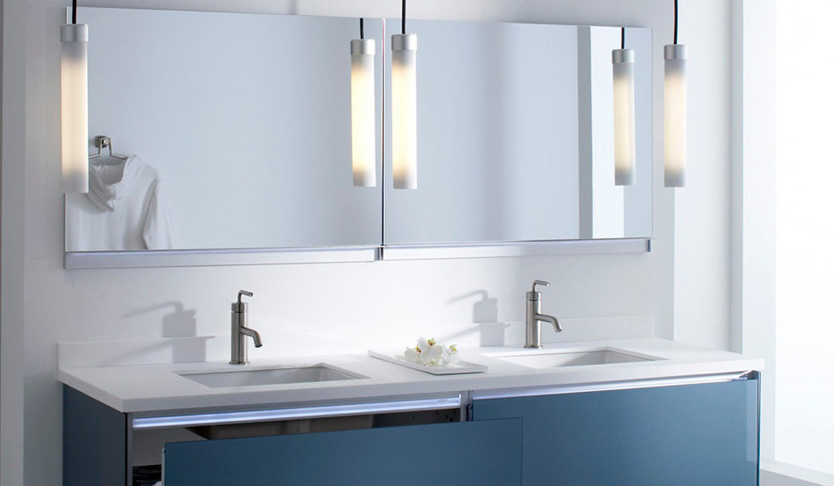 A modern double bathroom vanity featuring three modern sconces for task lighting over the vanity sinks.