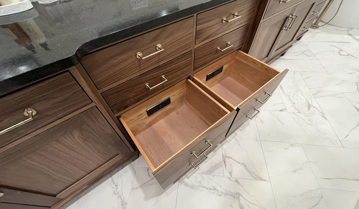 Two woodgrain bathroom vanity drawers, each featuring a Docking Drawer in-drawer outlet.