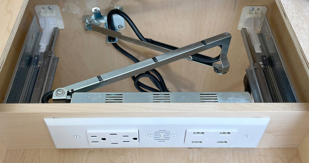 View behind a drawer box showing the function of Docking Drawer's cable management arm, protecting the outlet cord.