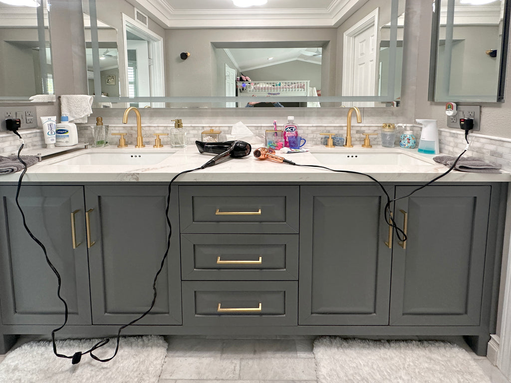 Modern bathroom remodel with countertop clutter from styling tool devices.