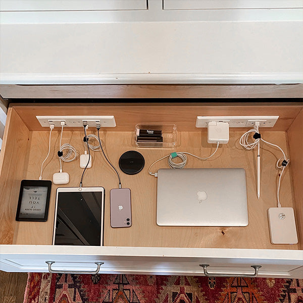 Docking Drawer charging station with smart devices using colored cable ties for in-drawer cord organization.