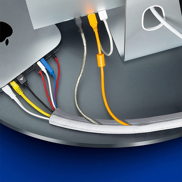 Multiple colored cables funneling into a single cable sleeve for optimal cord organization.