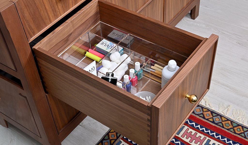 Wooden vanity drawer with a drawer organizer a variety of bathroom essentials.