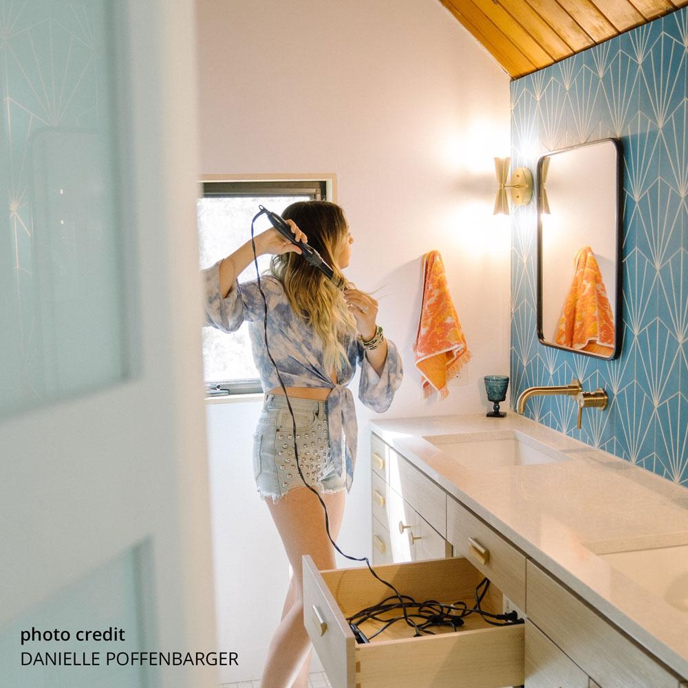 woman blow drying hair