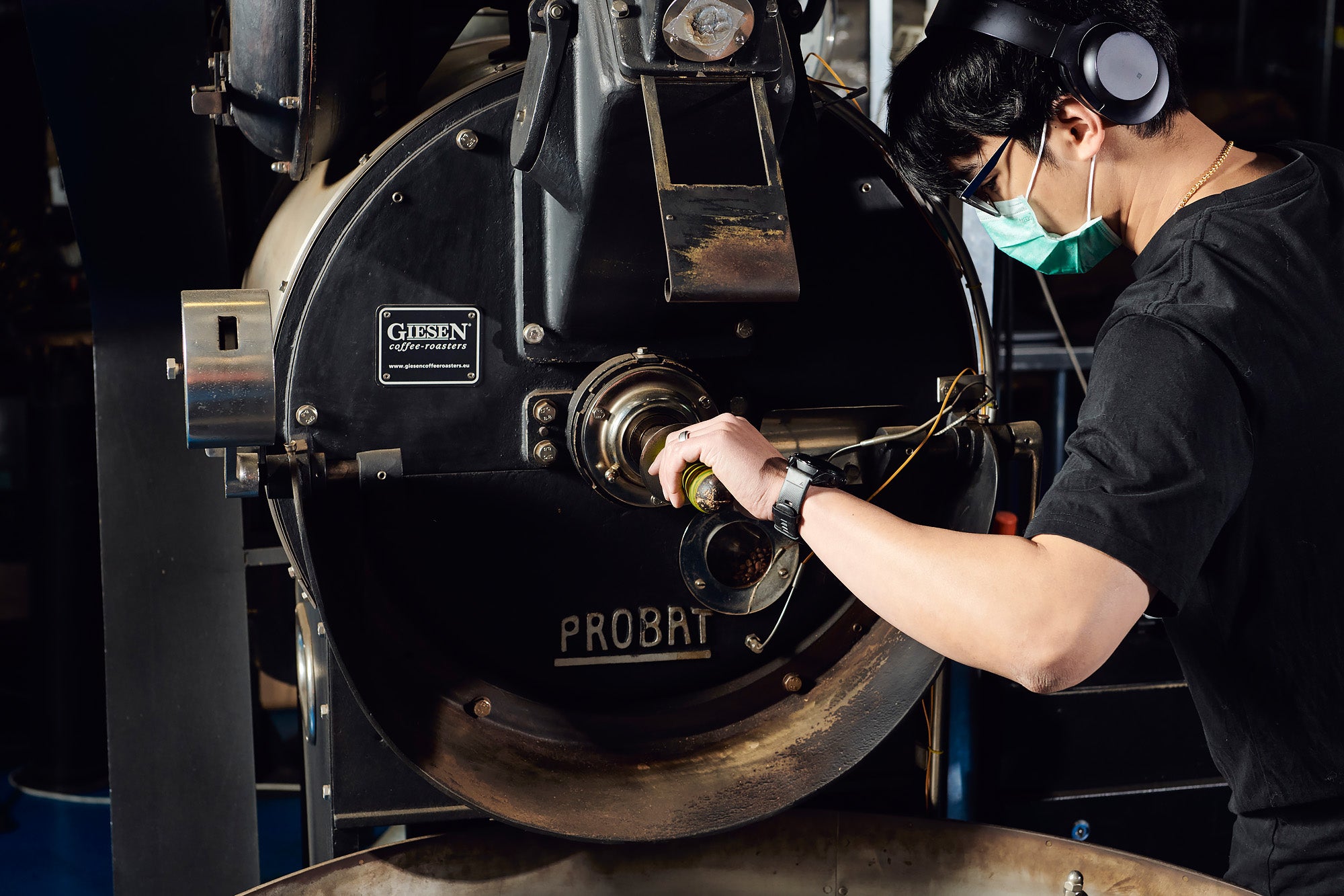 Man working at a large coffee roaster 