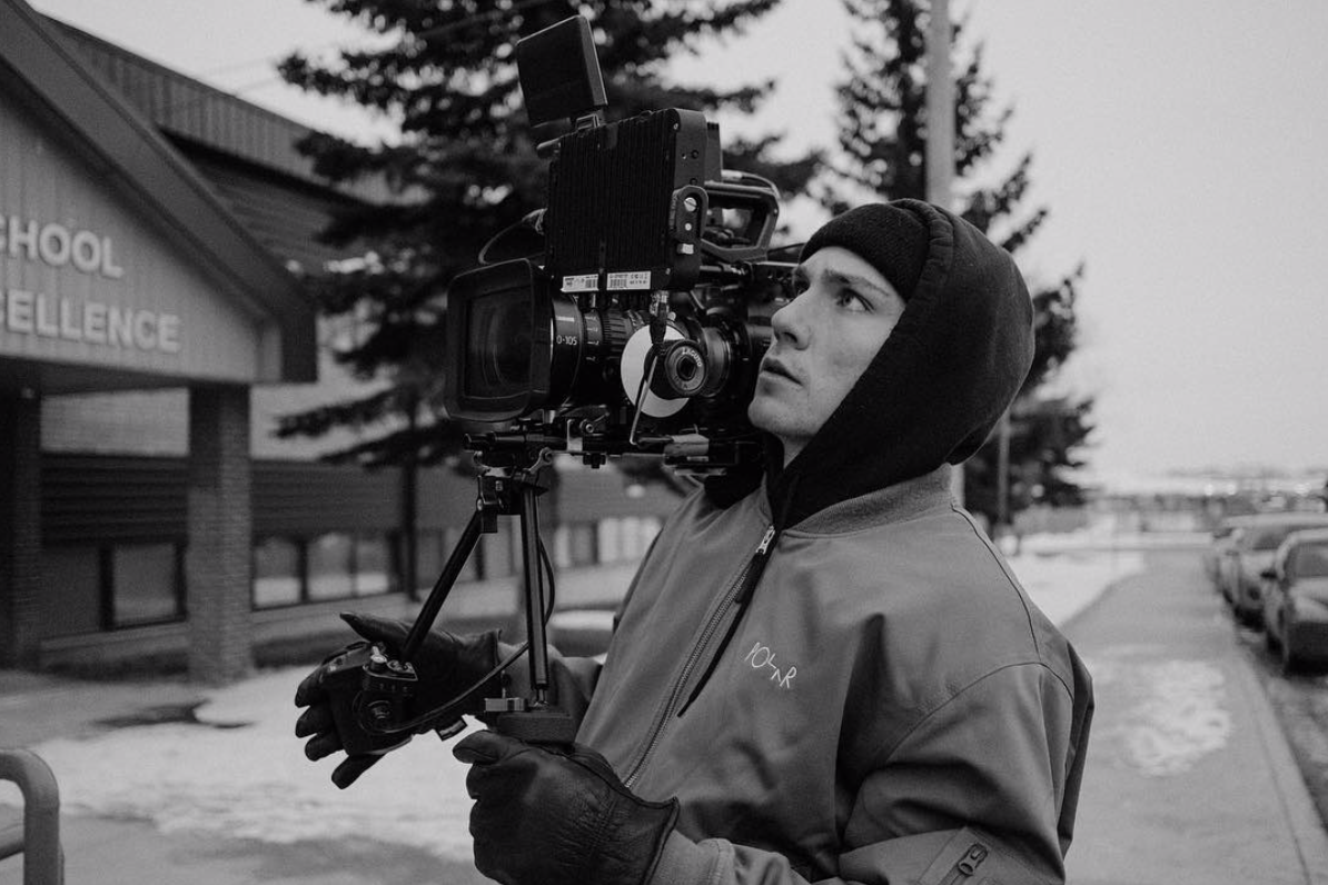Noah Leach looking in his camera on a film set