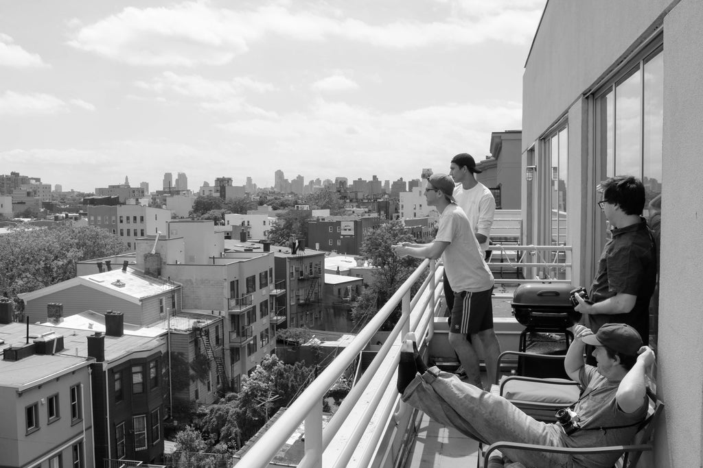 Friends on a balcony overlooking New York