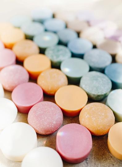 an assortment of soap bars lined up by color