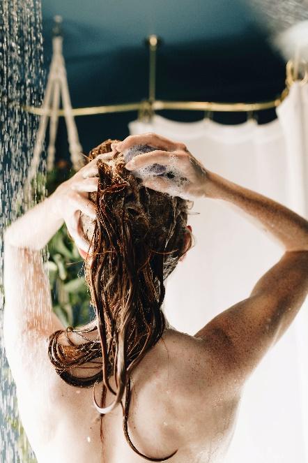 a woman shampooing her hair