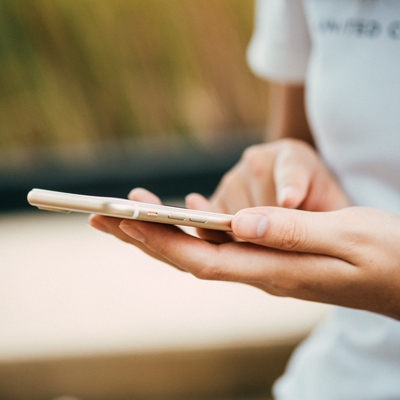 A woman uses her smart phone to sign up for a newsletter