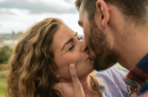 a couple kissing outdoors