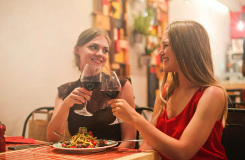 two women on a date drinking wine
