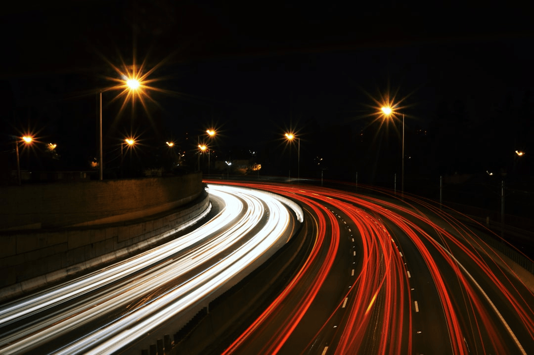 Image of traffic speeding by on the highway at night