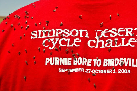 Photo of flies on a red T-shirt, Simpson Desert Cycle Challenge, taken by Mike Fewster.
