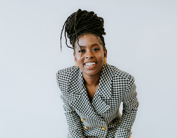 Woman smiling in a Chanel suit