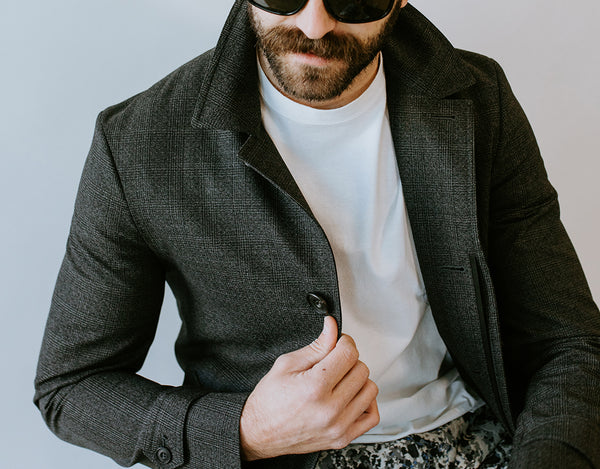 Man wearing luxury designer jacket and sunglasses