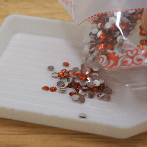 Pouring Crystal Diamonds Into Tray