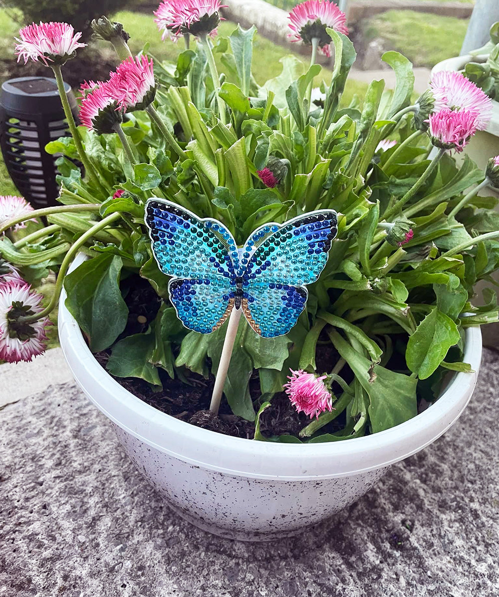A bedazzled butterfly in a flowerpot 