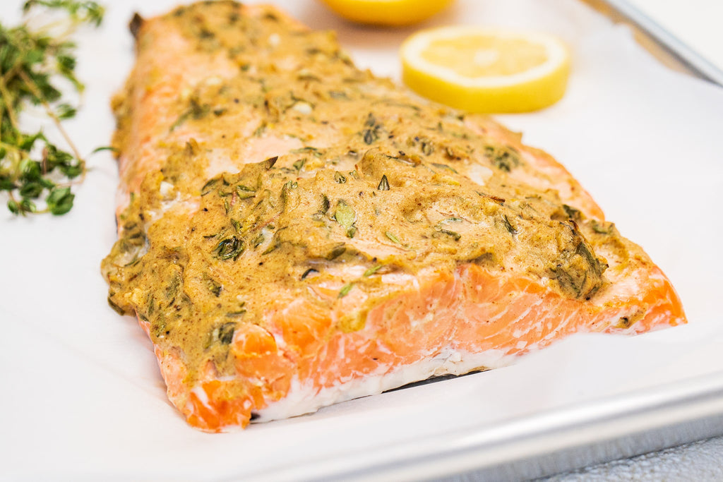 A cooked salmon filet made with Primal Kitchen Dijon Mustard. 