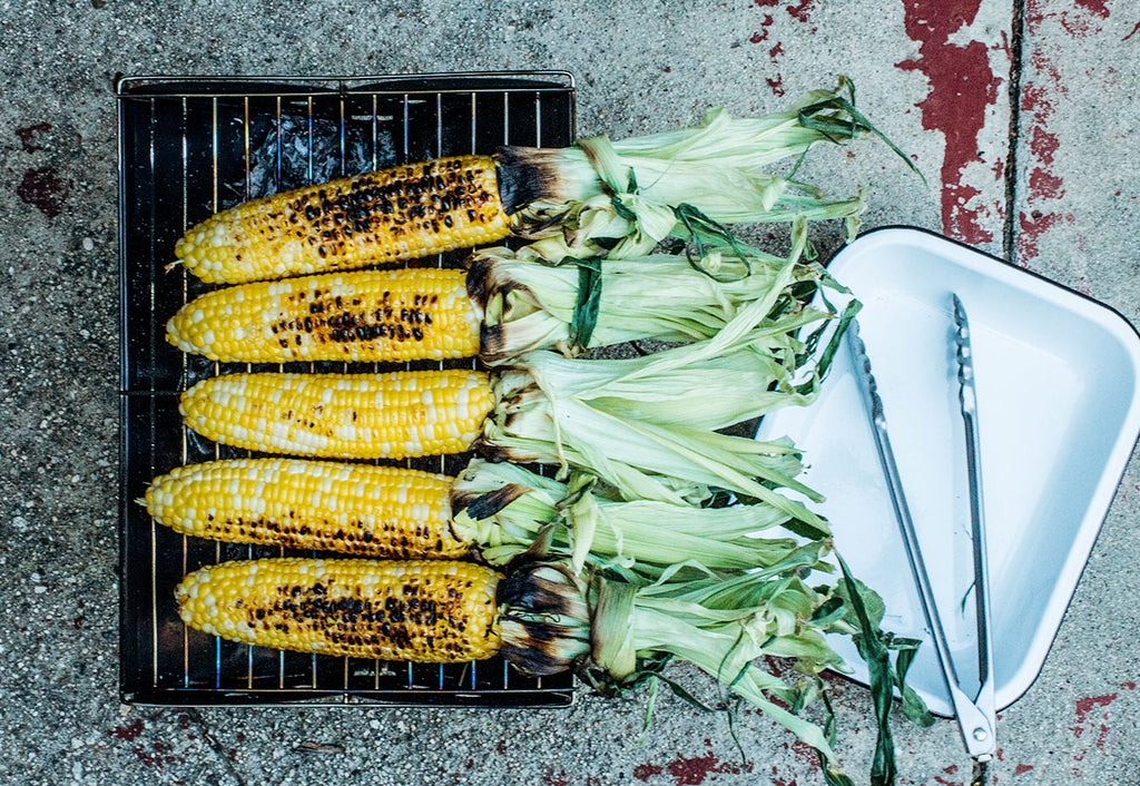 elote corn cobs on a grill