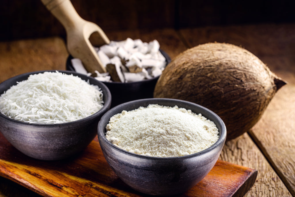 Coconut and bowls of coconut flour