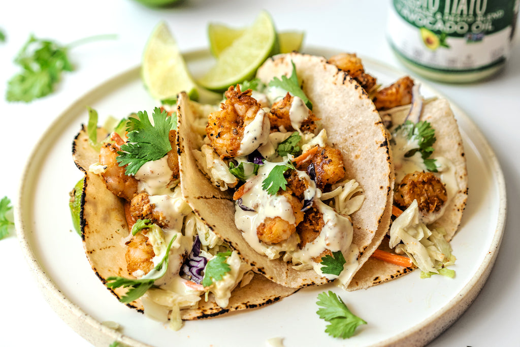 Three Pesto Shrimp Tacos on a white plate.