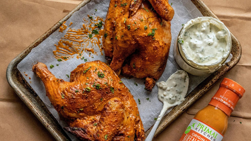 Buffalo half chicken on a metal baking tray