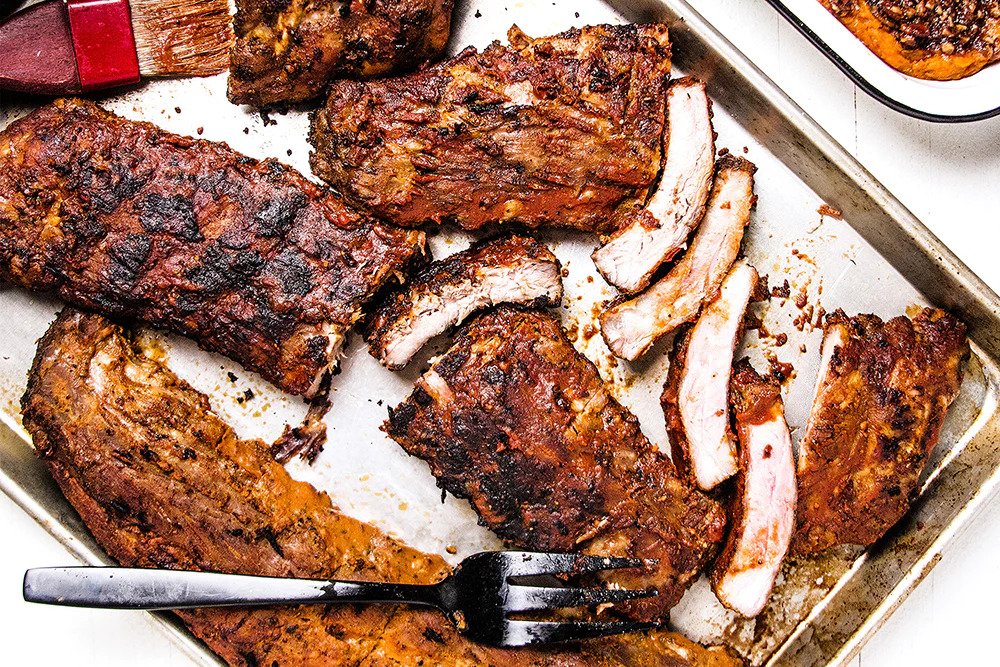 Baby back ribs on a metal baking sheet