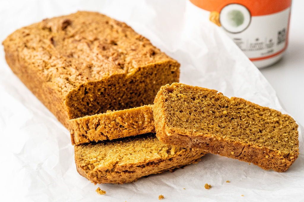 A partially sliced loaf of gluten-free peanut butter bread made with Primal Kitchen Collagen. 