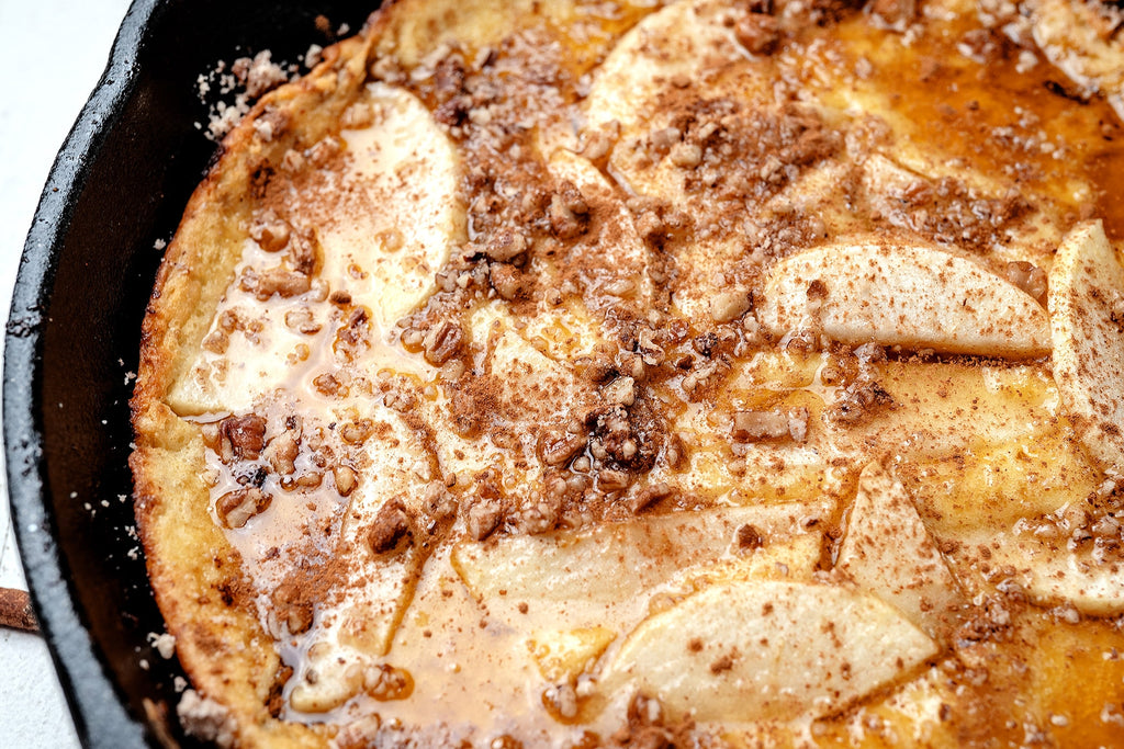 Closeup on a baked apple pancake made with Primal Kitchen Collagen. 