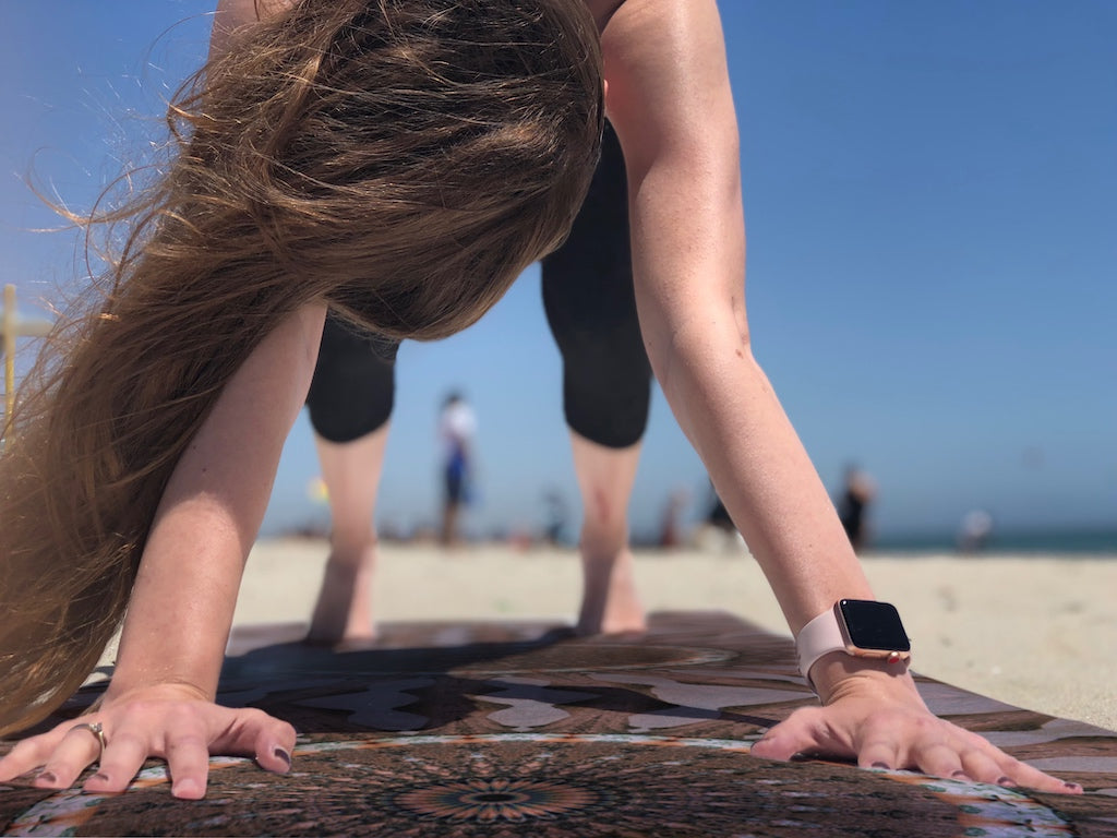 Hannah doing yoga on the beach