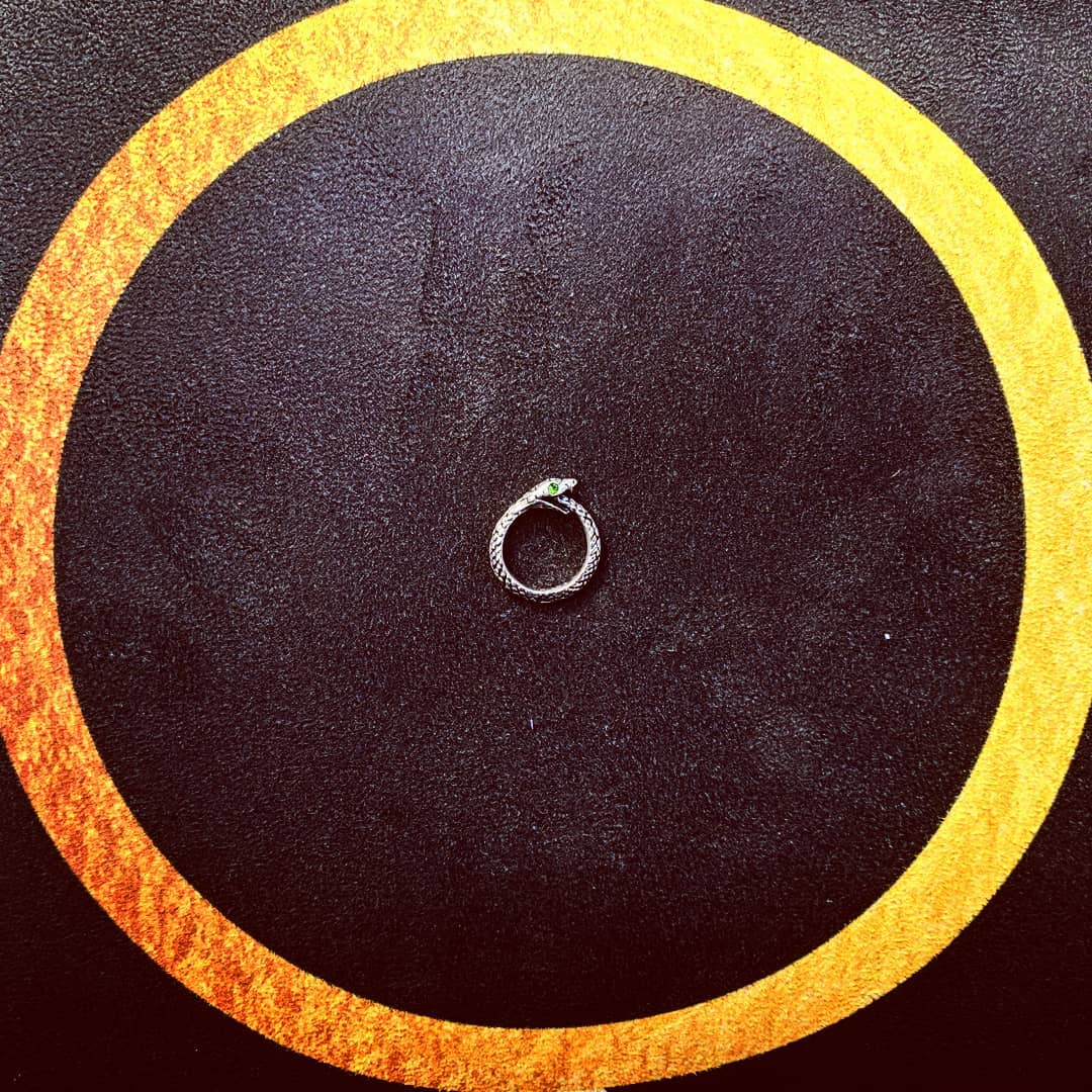 Ouroboros pendant on a 'Waxing Crescent Phases of the Moon' Big Raven Yoga mat