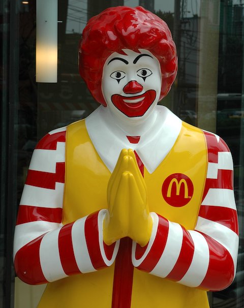 Ronald McDonald Greeting Customers in Thailand with a Wai Gesture
