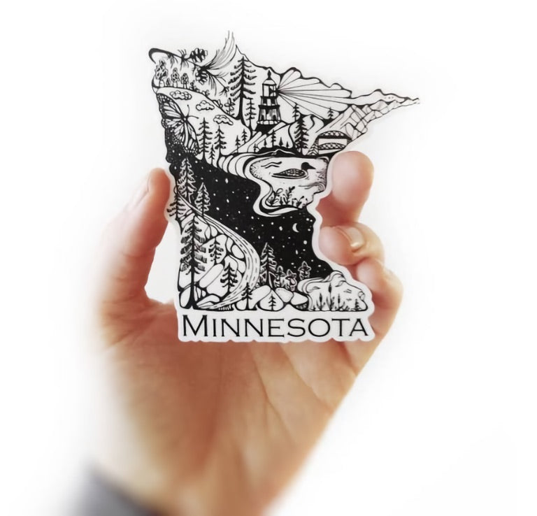 Nicole Labonte holding her Minnesota sticker