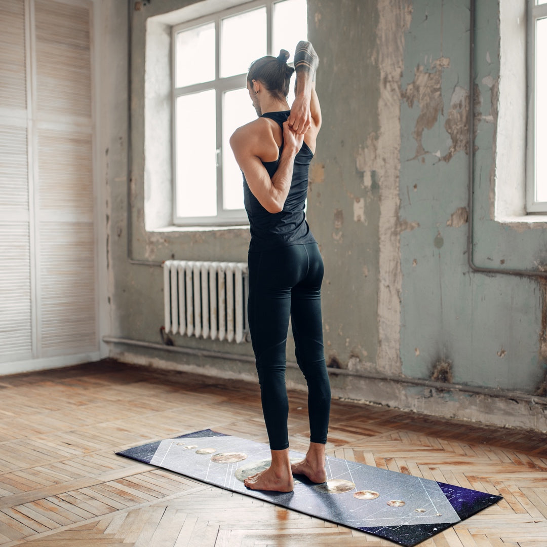 Photo of a man doing yoga on a Moons in the Sky Yoga Mat