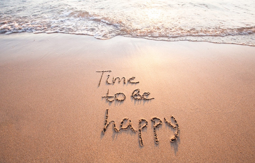 Time to Be Happy written in the sand on the beach