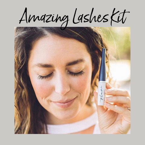 Image of woman with long eyelashes holding Plume Lash Serum