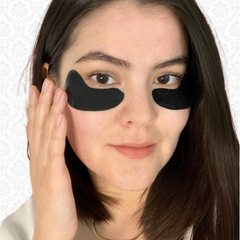 Image of woman wearing Consonant's black reusable silicone eye masks on well&belle