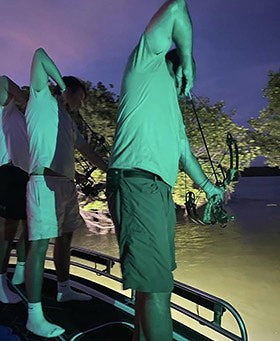 bowfishing at night with bright lights for invasive species